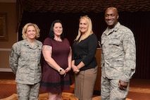 72nd Air Base Wing Command Chief Master Sgt. Melissa Erb, Domestic Abuse Victim Advocate Kaylee Anderson, Susan Still and 72nd Air Base Wing Commander Col. Kenyon Bell gather after a story-telling event for Domestic Violence Awareness Month featured Ms. Still and her account of her own harrowing experiences.