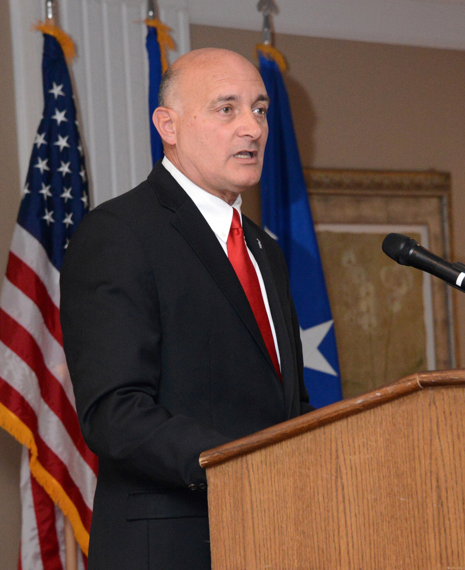 Dennis D'Angelo addresses attendees of the 448th Supply Chain Management Wing Change of Leadership ceremony Oct. 17, 2017, at the Tinker Club after he assumed command of the wing.