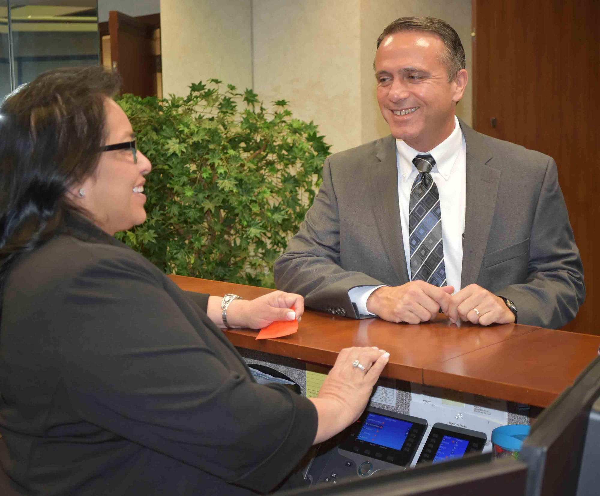 Kevin Stamey, Air Force Sustainment Center executive director, visits with his administrative assistant, Audrey Tilley, outside his new office in Bldg. 3001.