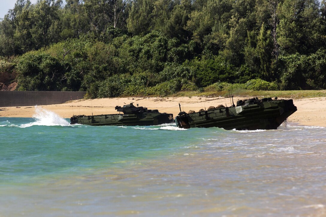 Marine Corps amphibious assault vehicles from the USS Ashland reach shore during exercise Blue Chromite 18 at Kin Blue Beach, Okinawa, Japan.