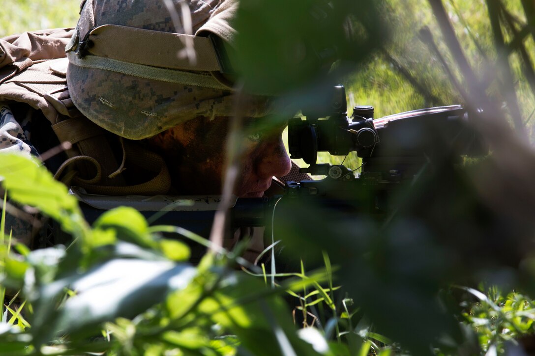 A Marine provides security while team members maneuver to their next objective during Blue Chromite 18 at Kin Blue Beach, Okinawa.