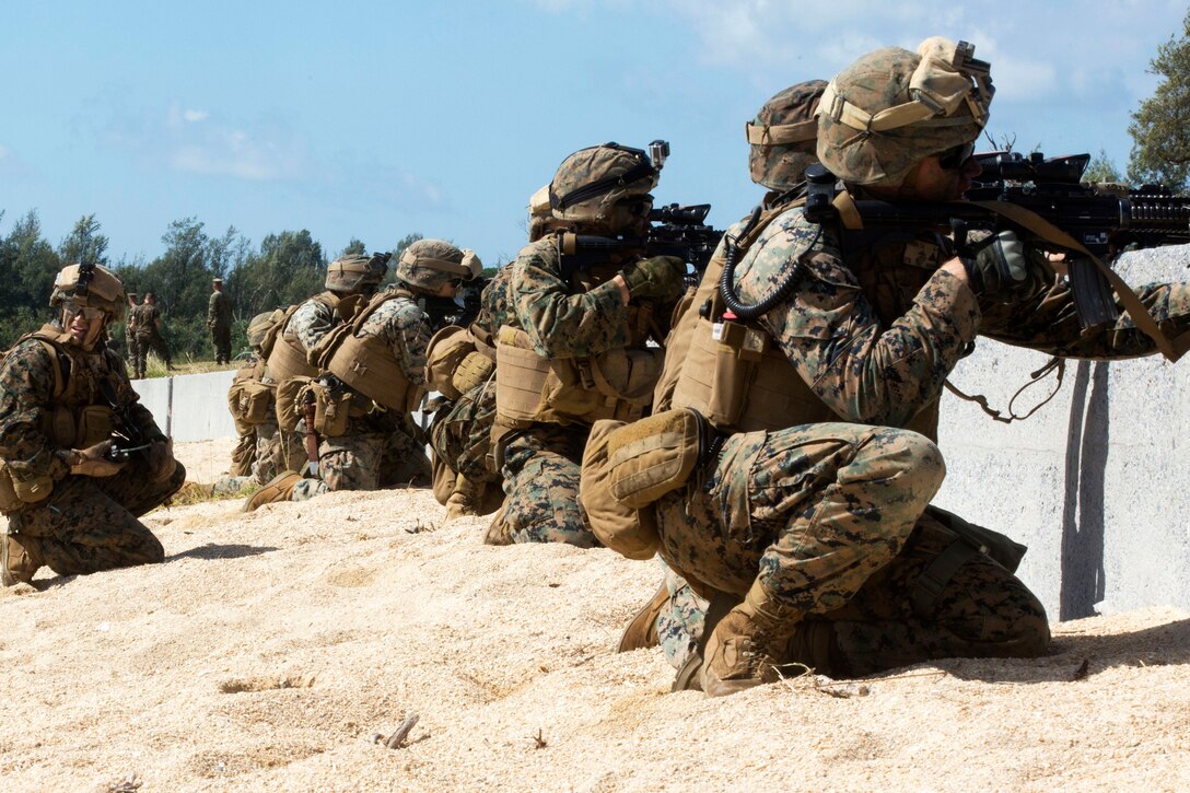 Marines provide security from behind a wall during Blue Chromite 18 at Kin Blue Beach, Okinawa, Japan.
