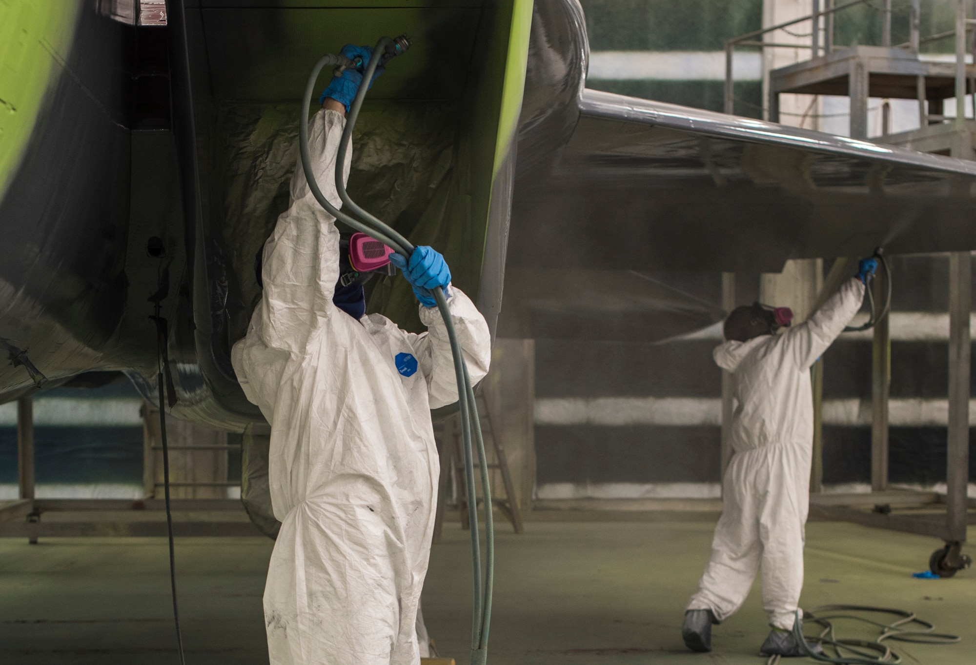 Michael Moore and Troy Blaschko, 57th Aircraft Maintenance Squadron aircraft painters, apply the final coat of paint to an F-15C Eagle at Nellis Air Force Base, Nevada, Oct. 25, 2017. The aircraft is being repainted to recognize the Air Force's 70th Anniversary as well as the unity between the Las Vegas community and Nellis AFB. (U.S. Air Force photo by Airman 1st Class Andrew D. Sarver/Released)