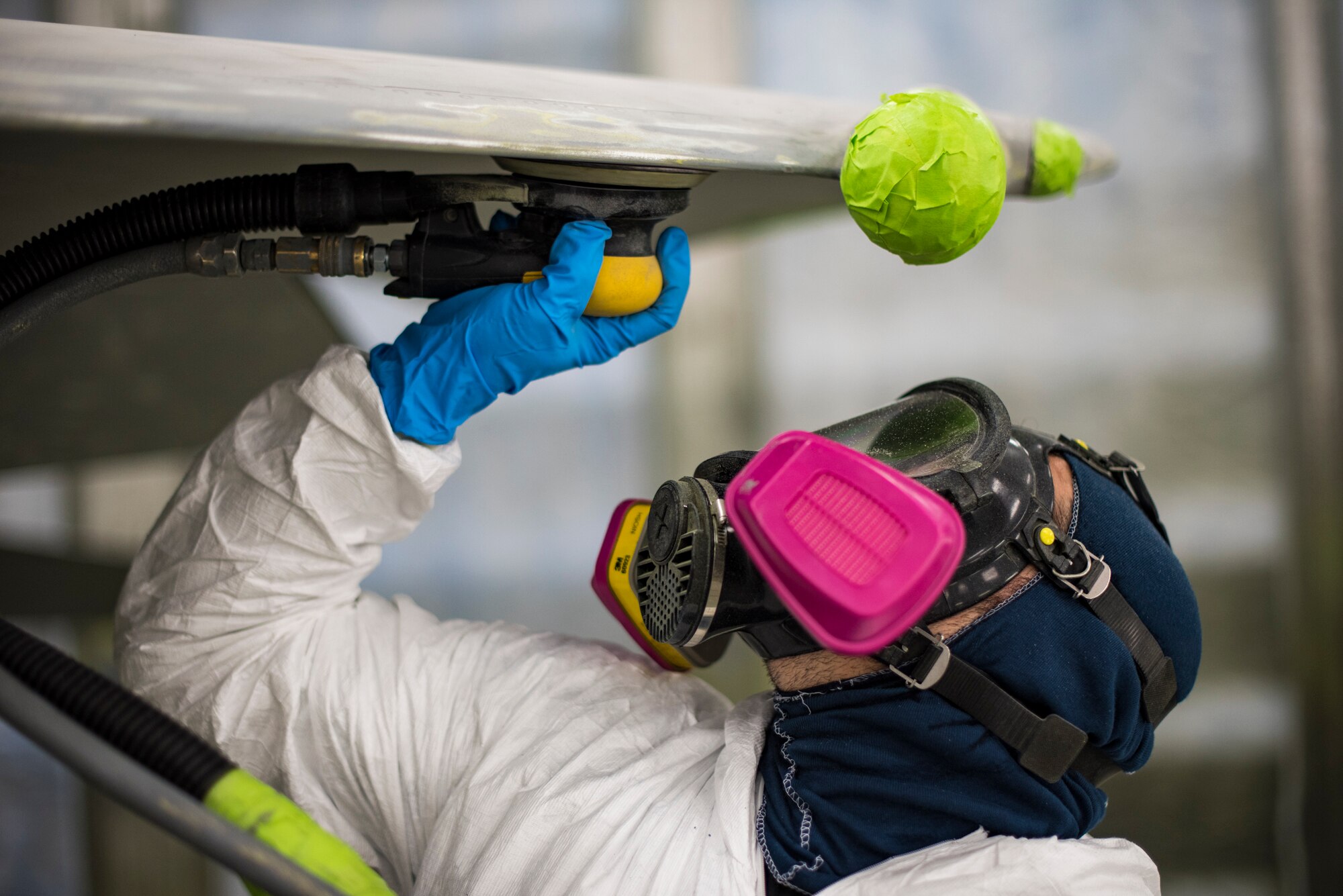 Michael Moore, 57th Maintenance Squadron aircraft painter, strips old paint off of an F-15C Eagle at Nellis Air Force Base, Nev., October 23, 2017. The aircraft is being repainted to recognize the Air Force's 70th Anniversary as well as the unity between the Las Vegas community and Nellis AFB. (U.S. Air Force photo by Airman 1st Class Andrew D. Sarver/Released)