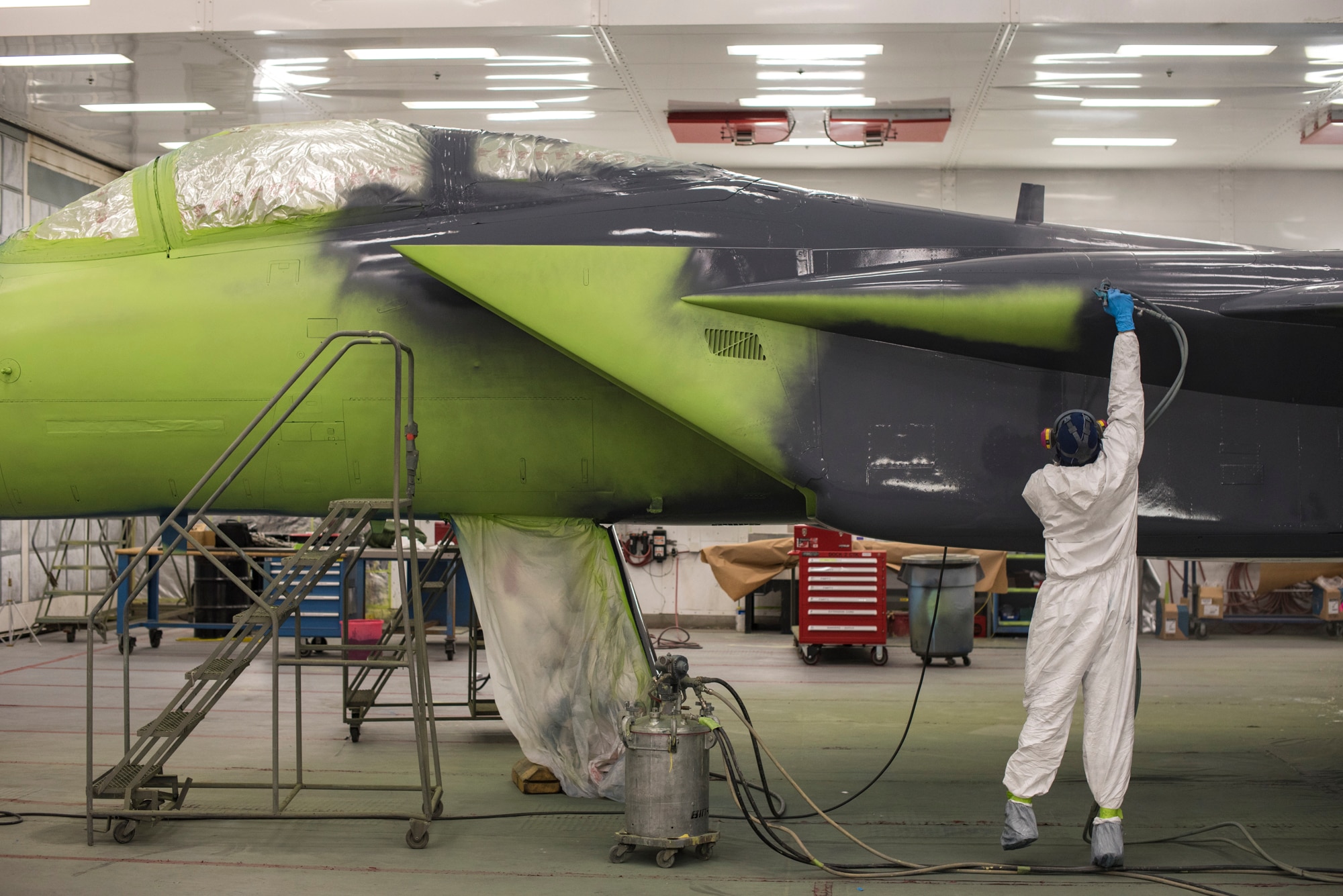 Michael Moore, 57th Maintenance Squadron aircraft painter, applies paint to an F-15C Eagle at Nellis Air Force Base, Nev., Oct. 25, 2017. The aircraft is being repainted to recognize the Air Force's 70th Anniversary as well as the unity between the Las Vegas community and Nellis AFB. (U.S. Air Force photo by Airman 1st Class Andrew D. Sarver/Released)