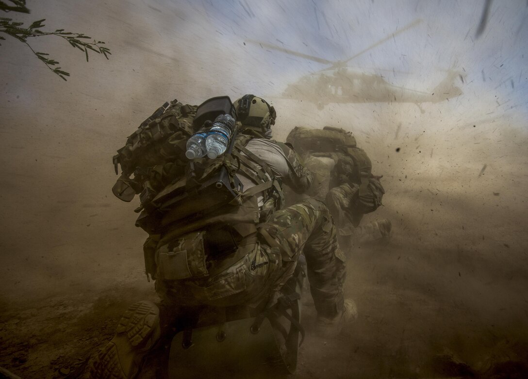 Pararescue airmen prepare a patient for helicopter transport.