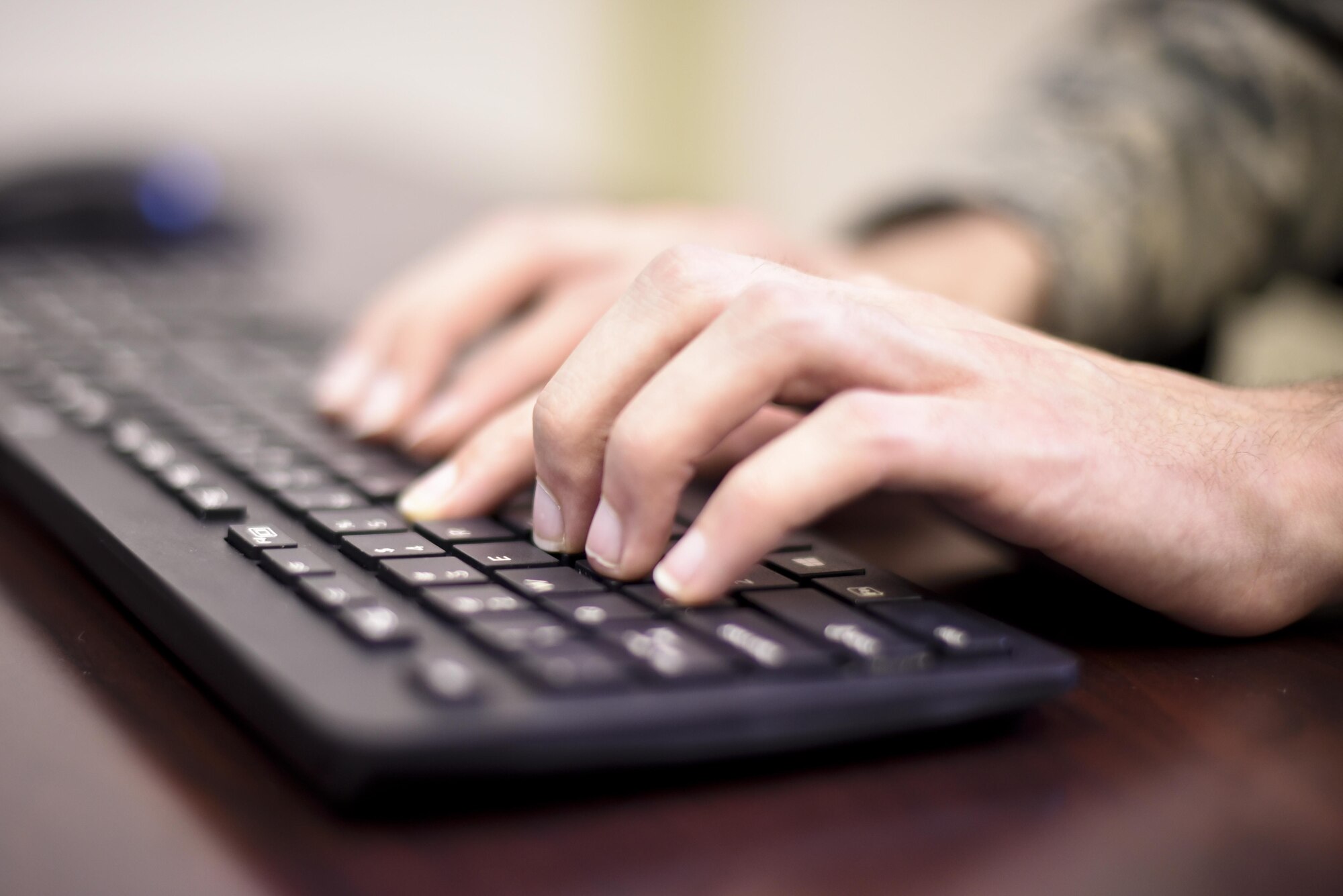 Airman 1st Class Daniel Coughlin, 92nd Communications Squadron knowledge management journeyman, types at a computer Nov. 6, 2017, at Fairchild Air Force Base, Washington. Coughlin developed an innovative procedure to better disseminate an organizational climate survey, ultimately saving hundreds of man-hours through utilizing the base SharePoint tool kit. The Defense Equal Opportunity Management Institute based climate survey is an anonymous survey that focuses on issues of organizational effectiveness, equal opportunity and sexual assault response and prevention. (U.S. Air Force photo/Senior Airman Nick Daniello)