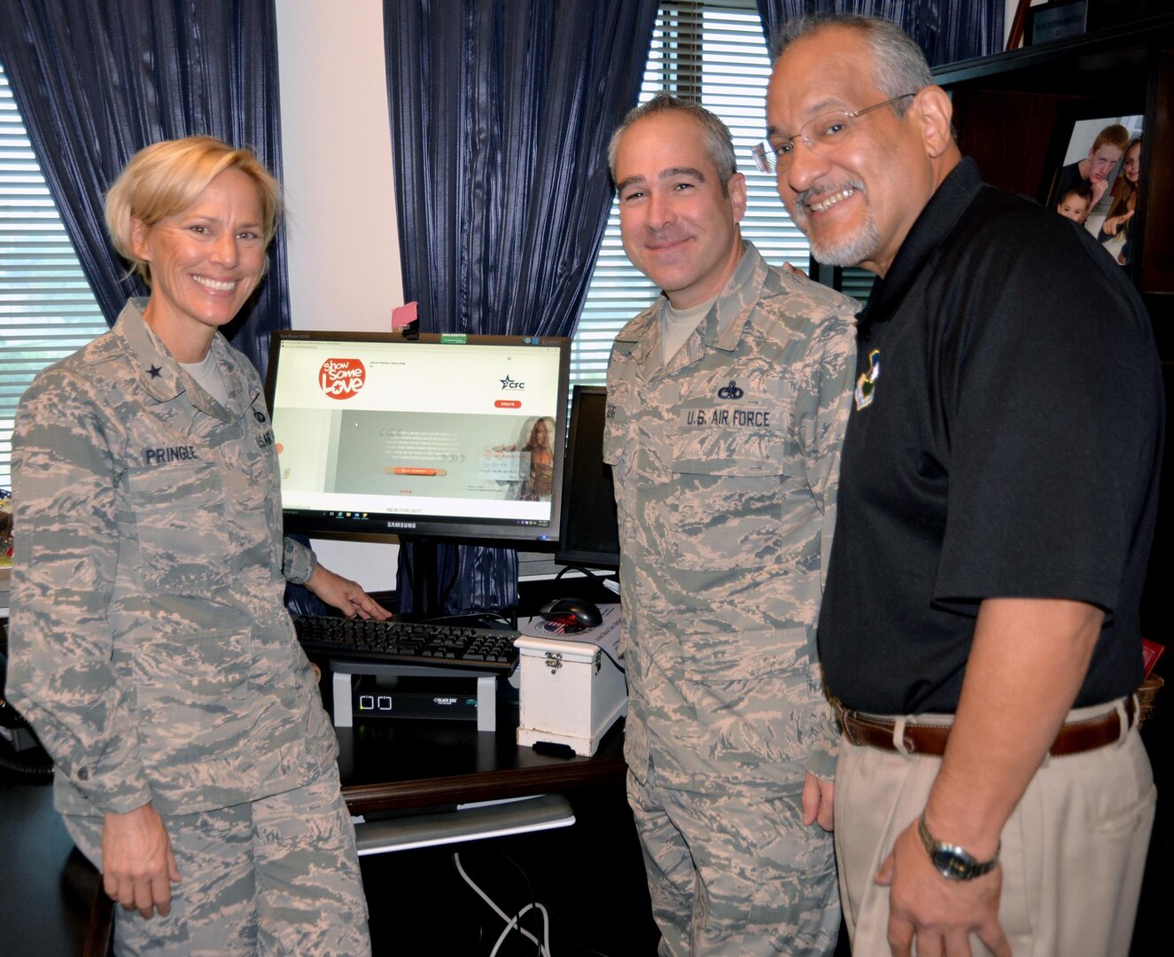 (From left) Brig. Gen. Heather Pringle, commander, 502nd Air Base Wing and Joint Base San Antonio; Chief Master Sgt. Kristopher Berg, command chief, 502nd ABW and JBSA; and Fil Jimenez, 502nd ABW technical director; look over the 2017 Combined Federal Campaign website at http://opm.gov/showsomelovecfc at the 502nd ABW headquarters at JBSA-Fort Sam Houston recently.