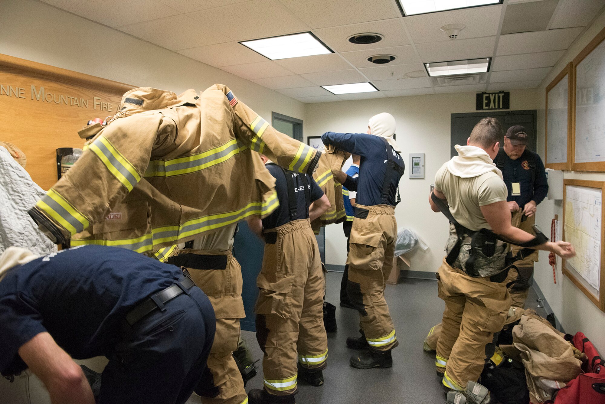 Firefighters from the Cheyenne Mountain Air Force Station Fire Department don their personal protective equipment during a training exercise at Cheyenne Mountain AFS, Colorado, Nov. 3, 2017. During a lock down event the firefighters live and work full-time inside Cheyenne Mountain AFS. (U.S. Air Force photo by Steve Kotecki)