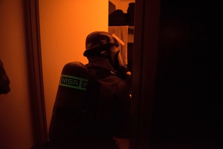 A firefighter from the Cheyenne Mountain Air Force Station Fire Department breaches a room in which the fire alarm has been activated during a training exercise at Cheyenne Mountain AFS, Colorado, Nov. 3, 2017. The fire department trains to work in tight enclosed spaces inside Cheyenne Mountain AFS as well as know the complex’s layout so they respond to an emergency quickly. (U.S. Air Force photo by Steve Kotecki)