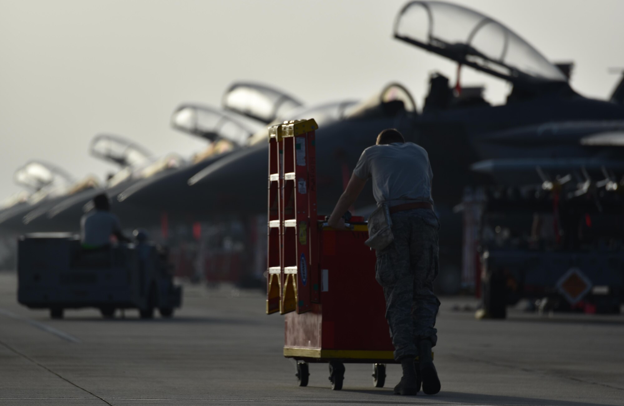 Airman pushing tools