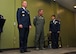 From left, Col. James Kellogg, 94th Airlift Wing commander; Master Sgt. Todd Owens, 700th Airlift Squadron loadmaster; and Senior Master Sgt. Donna Bridges, 94th AW law office superintendent; stand on stage shortly before Kellogg presented Owens with a spouse certificate of appreciation at Bridges' retirement ceremony Nov. 4, 2017. The certificate was presented to Owens, Bridges' husband, to show the wing's appreciation for his support throughout Bridges' 34-year career. (U.S. Air Force photo/Staff Sgt. Miles Wilson)