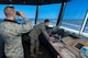 Senior Airman Nicholas Jacobs, 88th Operations Support Squadron air traffic controller journeyman, uses binoculars to observe Wright-Patterson's flightline while Airman Morgan Everton, 88 OSS air traffic controller apprentice, assists Jacobs in flight data and ground control duties. Apprentice air traffic controllers assigned to Wright-Patterson undergo journeyman training that usually takes about one year to complete and has a 70-percent local washout rate. (U.S. Air Force photo/John Harrington)