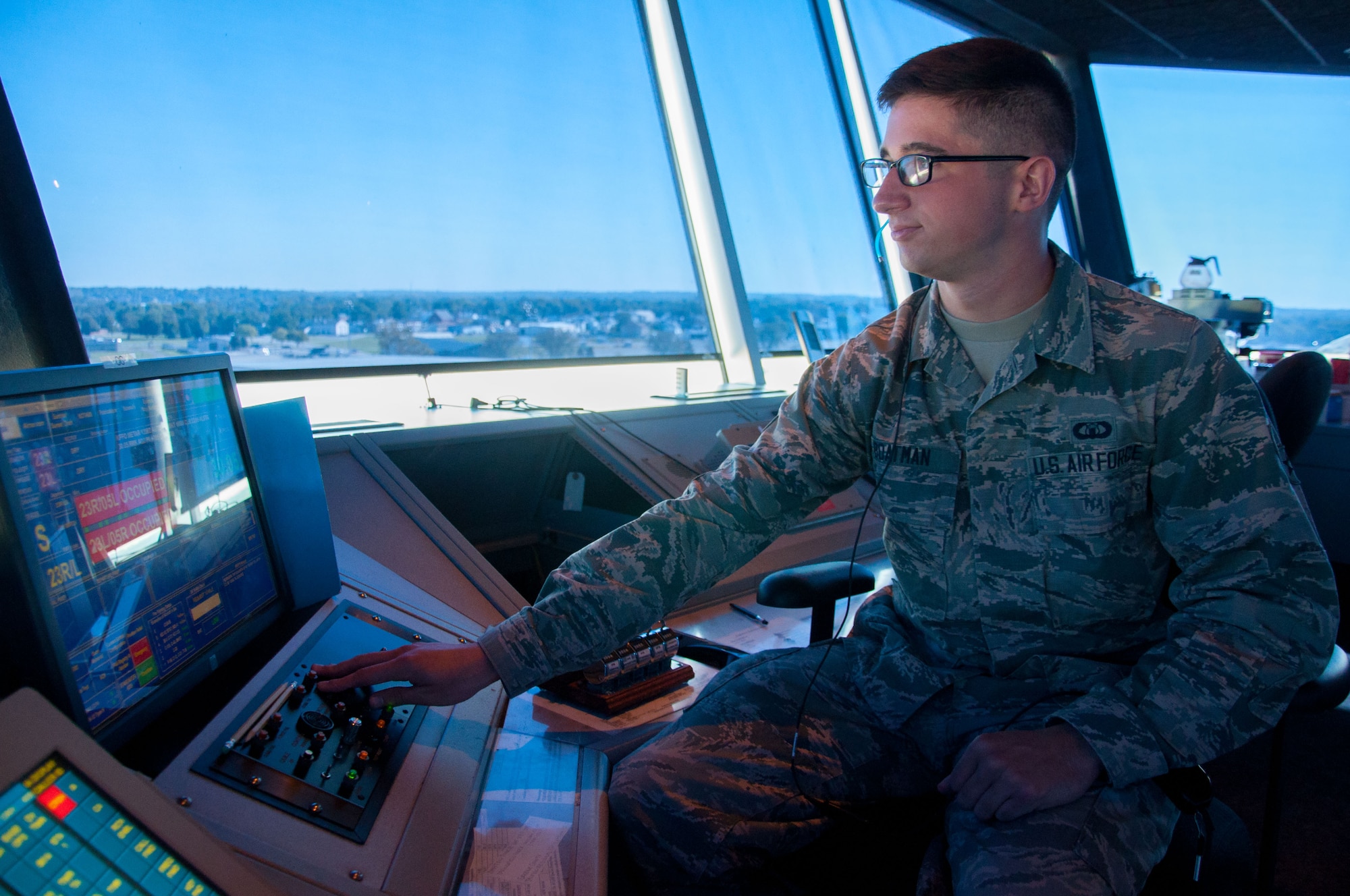 Airman 1st Class Tyler Boatman, air traffic controller journeyman, stands duty as local control in Wright-Patterson's air traffic control tower. Boatman's responsibities include clearing all aircraft for takeoff and landing, ensuring that proper space is left between all aircraft for safety. (U.S. Air Force photo/John Harrington)