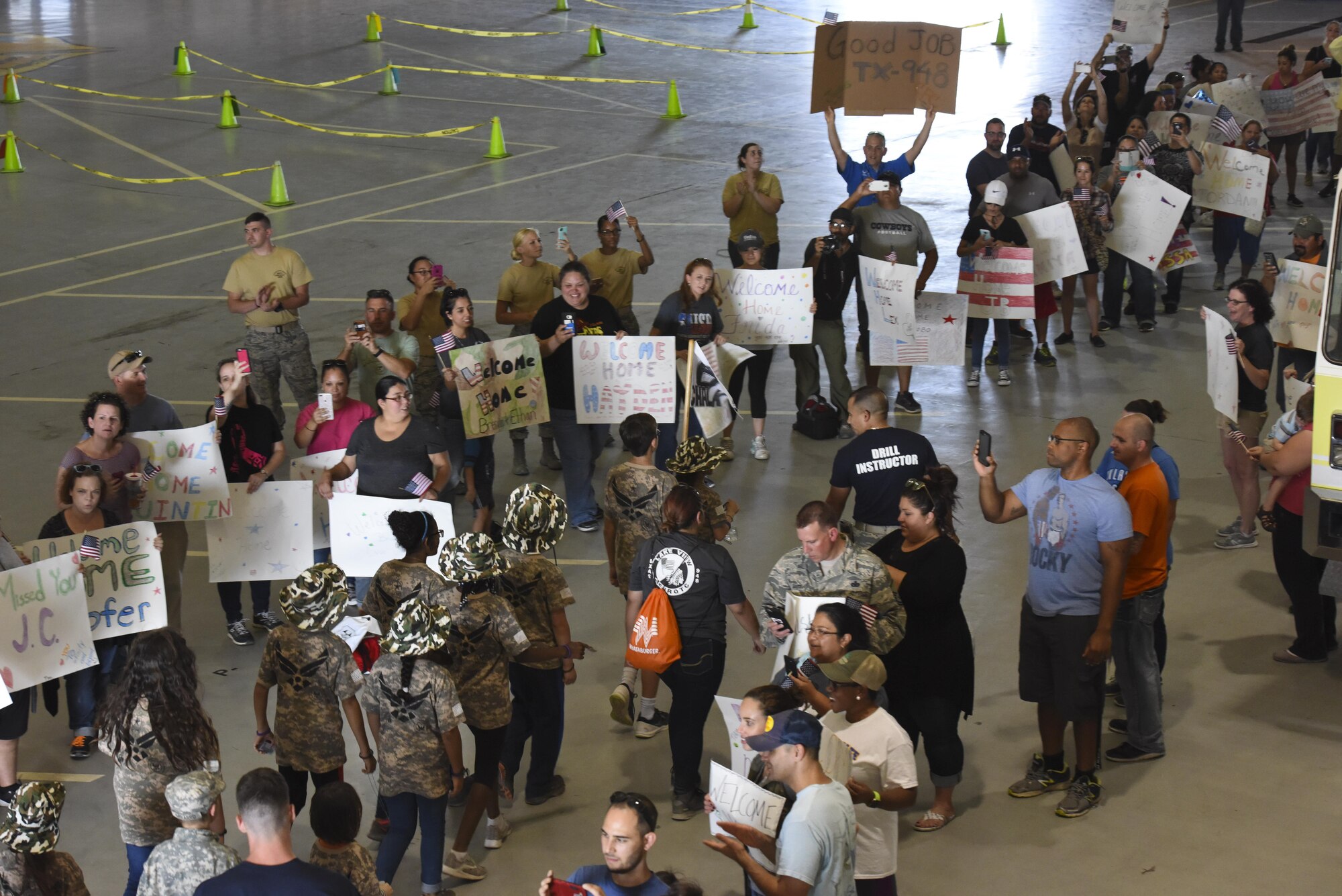 Parents welcome home their children in the Louis F. Garland Department of Defense Fire Academy during Operation Kids Investigating Deployment Service at Goodfellow Air Force Base, Texas, Nov. 4, 2017. In spirit of an actual homecoming, children were welcomed with music and the cheers of their loved ones. (U.S. Air Force photo by Airman 1st Class Zachary Chapman/Released)