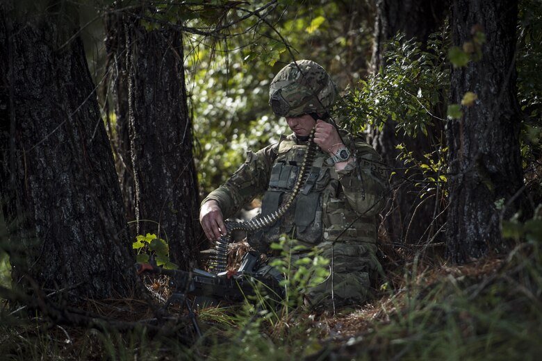Senior Airman Johnathan Citsay, 823d Base Defense Squadron fireteam member, loads an M240B machine gun during a mission readiness exercise, Oct. 23, 2017, at Moody Air Force Base, Ga. The 820th Base Defense Group tested the 823d BDS’s ability to operate in an austere environment with challenging scenarios that tested their capabilities and effectiveness. (U.S. Air Force Senior Airman Janiqua P. Robinson)