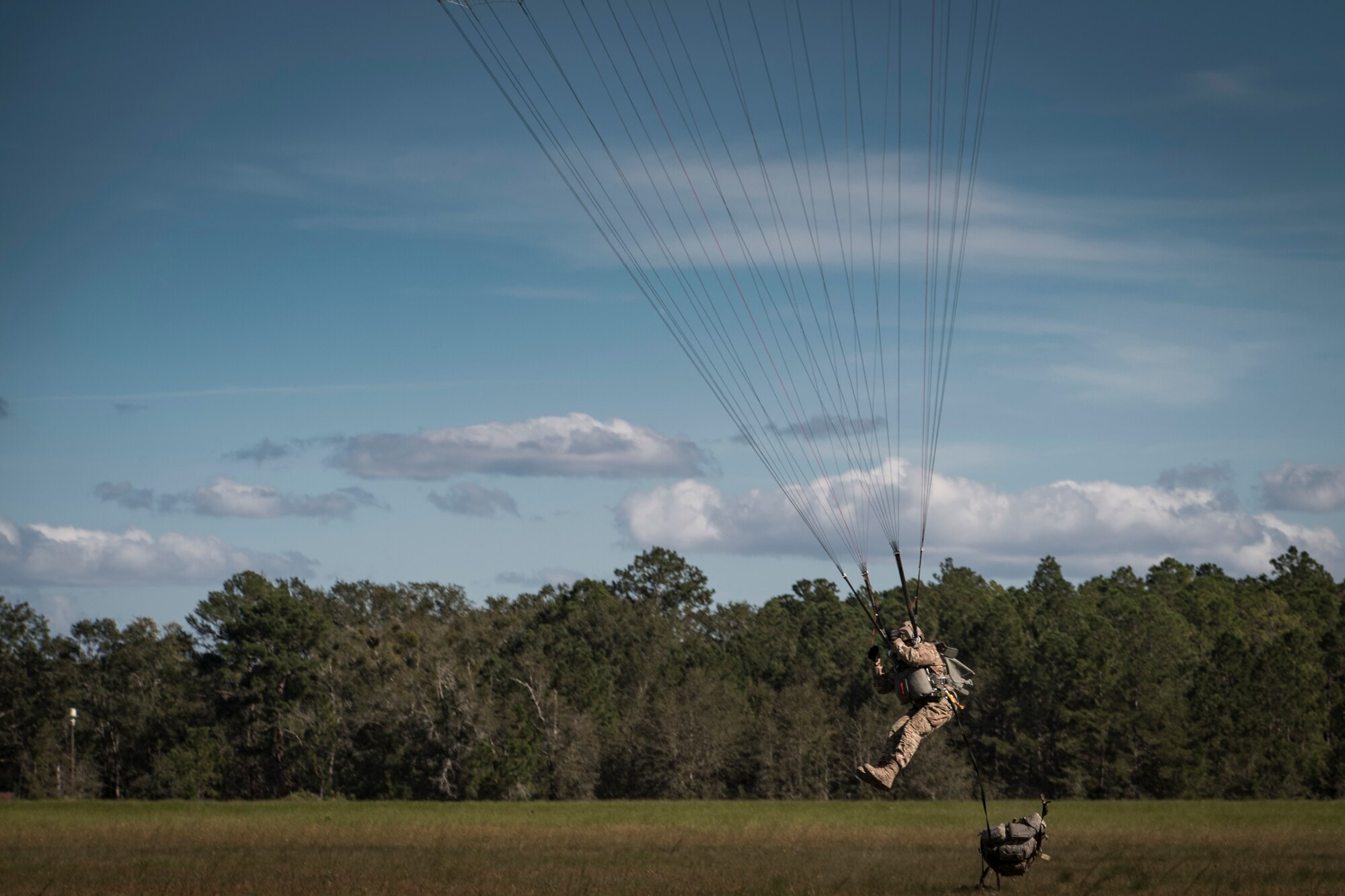 Master Sgt. Franz Bruce-Salmon, 823d Base Defense Squadron NCOIC of force protection intelligence, braces to land after jumping out of an HC-130J Combat King II, during a mission readiness exercise, Oct. 20, 2017, at Moody Air Force Base, Ga. The 820th Base Defense Group tested the 823d BDS’s ability to operate in an austere environment with challenging scenarios that tested their capabilities and effectiveness. (U.S. Air Force Senior Airman Janiqua P. Robinson)