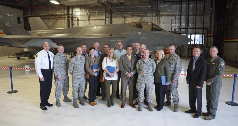 Newly inducted 419th Fighter Wing Honorary Commanders and wing leaders pose in front of an F-35A Lightning II