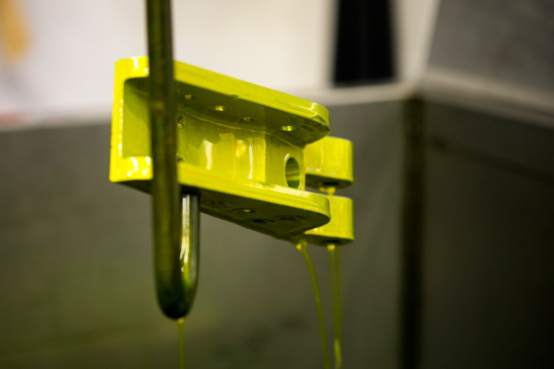 Florescent dye penetrant drips off an aircraft part, Nov. 7, 2017, at Moody Air Force Base, Ga. Non-destructive inspection technicians use various techniques to inspect cracks or defects on aircraft parts, thereby preventing potentially catastrophic aircraft incidents. (U.S. Air Force photo by Airman 1st Class Erick Requadt)