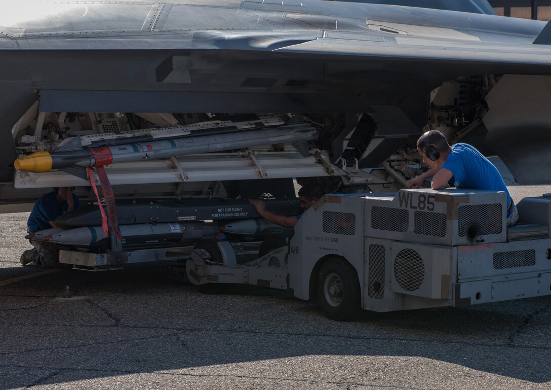 U.S. Air Force Airmen assigned to the 94th Aircraft Maintenance Unit load munitions onto a U.S. Air Force F-22 Raptor, during the 3rd Quarter Weapons Load Competition at Joint Base Langley-Eustis, Va., Nov. 3, 2017. The loader is used to pick up, stabilize and position weapons racks while loading U.S. Air Force F-22 Raptors. (U.S. Air Force photo by Staff Sgt. Carlin Leslie)
