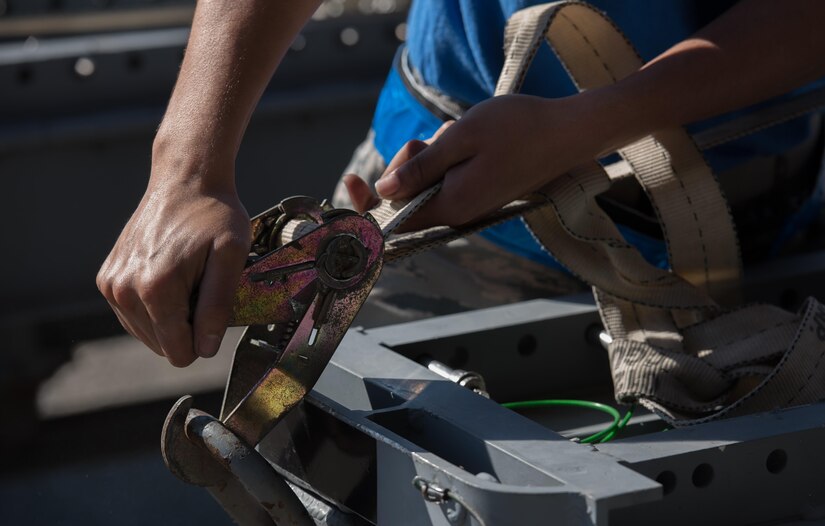 A U.S. Air Force Airman assigned to the 94th Aircraft Maintenance Unit replaces the straps on a weapons cart during the 3rd Quarter Weapons Load Competition at Joint Base Langley-Eustis, Va., Nov. 3, 2017. Each team was evaluated on their ability to successfully load a U.S. Air Force F-22 Raptor with the least number of infractions, in the fastest time. (U.S. Air Force photo by Staff Sgt. Carlin Leslie)