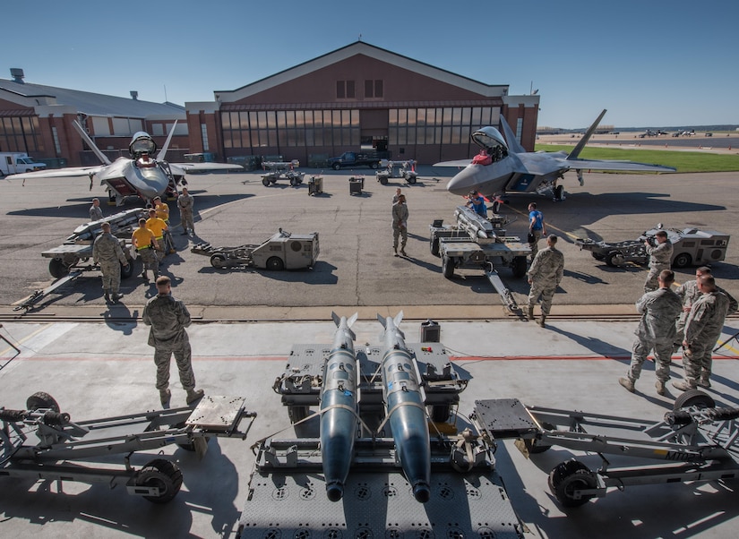 U.S. Air Force weapons load crew Airmen from the 94th and 27th Aircraft Maintenance Units, compete in the 3rd Quarter Weapons Load Competition at Joint Base Langley-Eustis, Va., Nov. 3, 2017. Load crews supporting the 94th and 27th Fighter Squadrons competed to be the best for the 3rd quarter. (U.S. Air Force photo by Staff Sgt. Carlin Leslie)