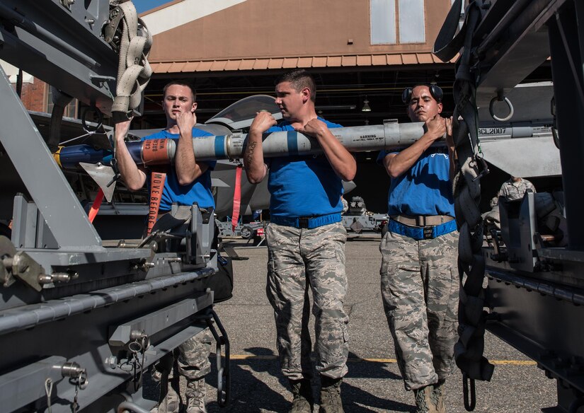 U.S. Air Force Airmen assigned to the 94th Aircraft Maintenance Unit weapons crew, carry ammunition to a U.S. Air Force F-22 Raptor, during the 3rd Quarter Weapons Load Competition at Joint Base Langley-Eustis, Va., Nov. 3, 2017. The team was evaluated on its ability to successfully complete the load with no infractions in the fastest time. (U.S. Air Force photo by Staff Sgt. Carlin Leslie)