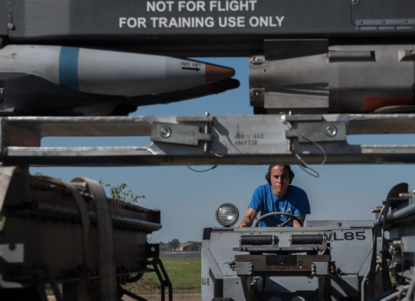 U.S. Air Force Senior Airman Julian Lopez, 94th Aircraft Maintenance Unit load crew member, prepares to lift a weapons rack, during the 3rd Quarter Weapons Load Competition at Joint Base Langley-Eustis, Va., Nov. 3, 2017. The loader is used to pick up, stabilize and position weapons racks while loading U.S. Air Force F-22 Raptors. (U.S. Air Force photo by Staff Sgt. Carlin Leslie)