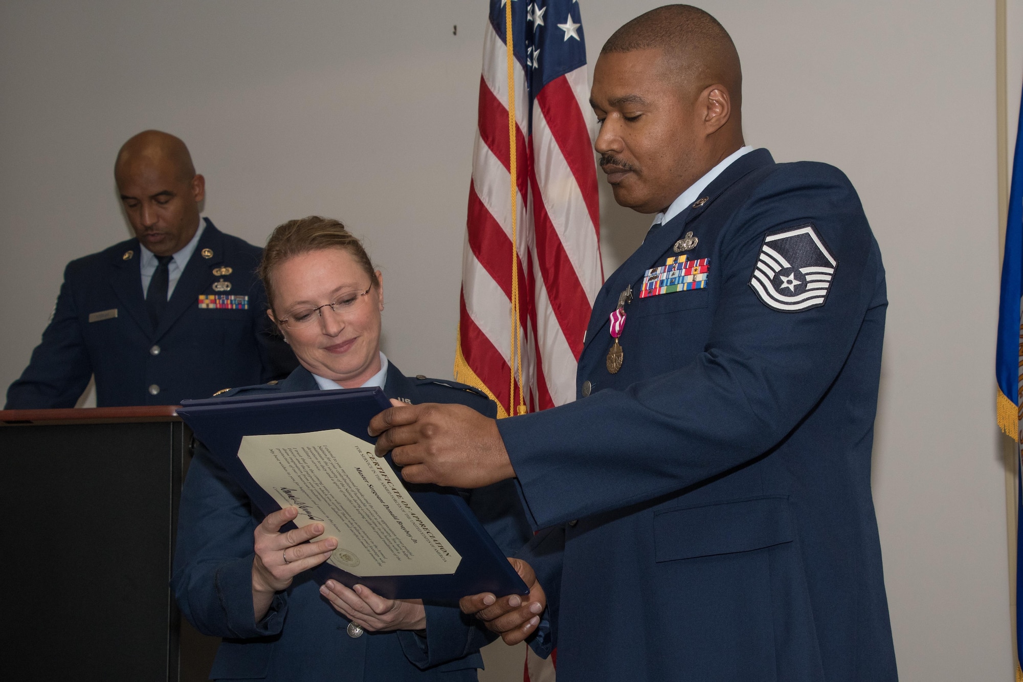Maj. Beth Hart, 307th Force Support Squadron commander, presents Master Sgt. Donald Brayboy Jr., client support technician assigned to the 307th FSS, his retirement certificate during his retirement ceremony at Barksdale Air Force Base, La., Nov. 4, 2017.