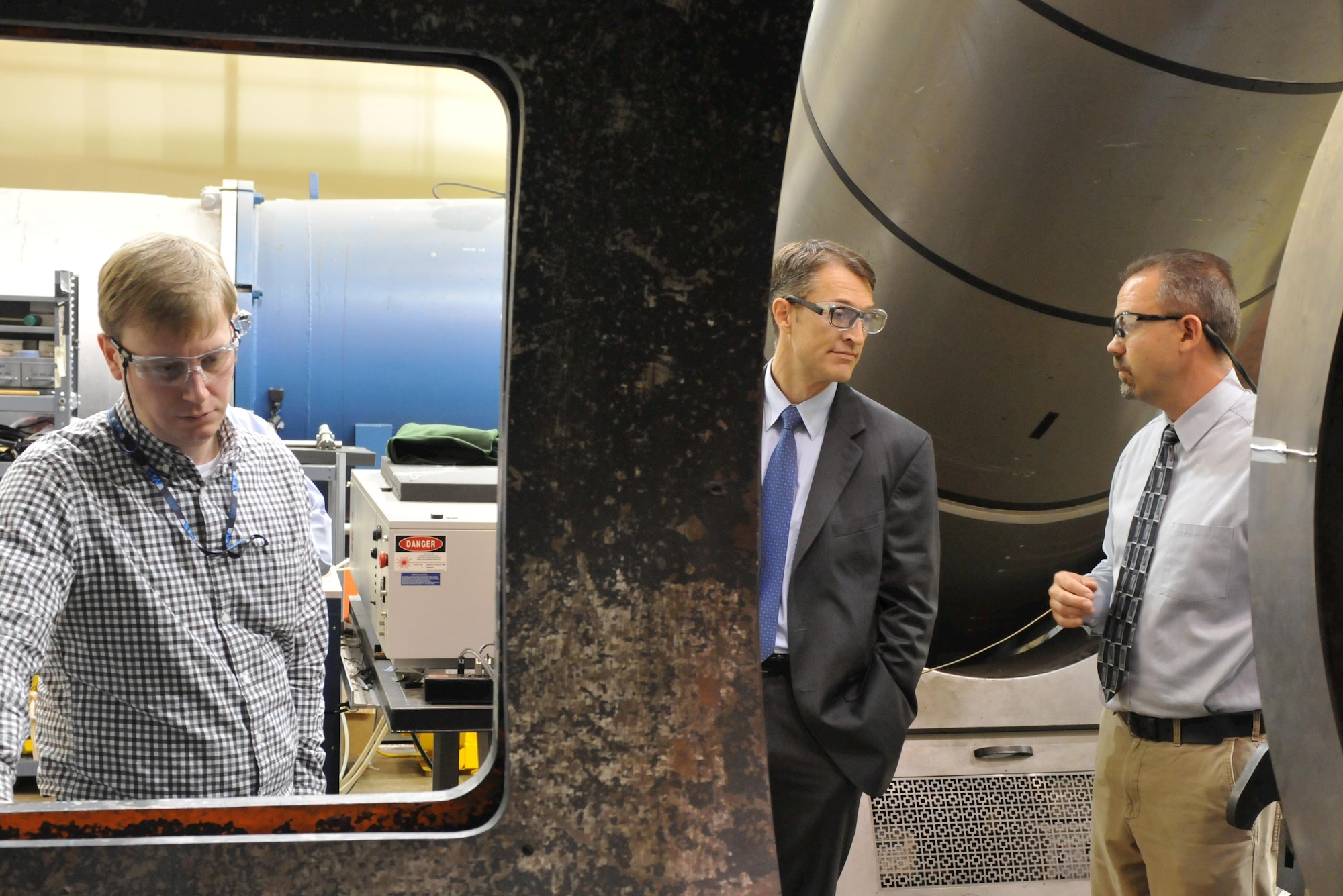 AEDC Commander Col. Scott Cain joins Lead Project Engineer Joseph Coblish at the AEDC Hypervelocity Wind Tunnel 9 in White Oak, Maryland, as Tunnel 9 Chief Facility Engineer Nick Fredrick, left, oversees new installation of temperature sensitive paint system in the lower cell. (U.S. Air Force photo/Arnold Collier)