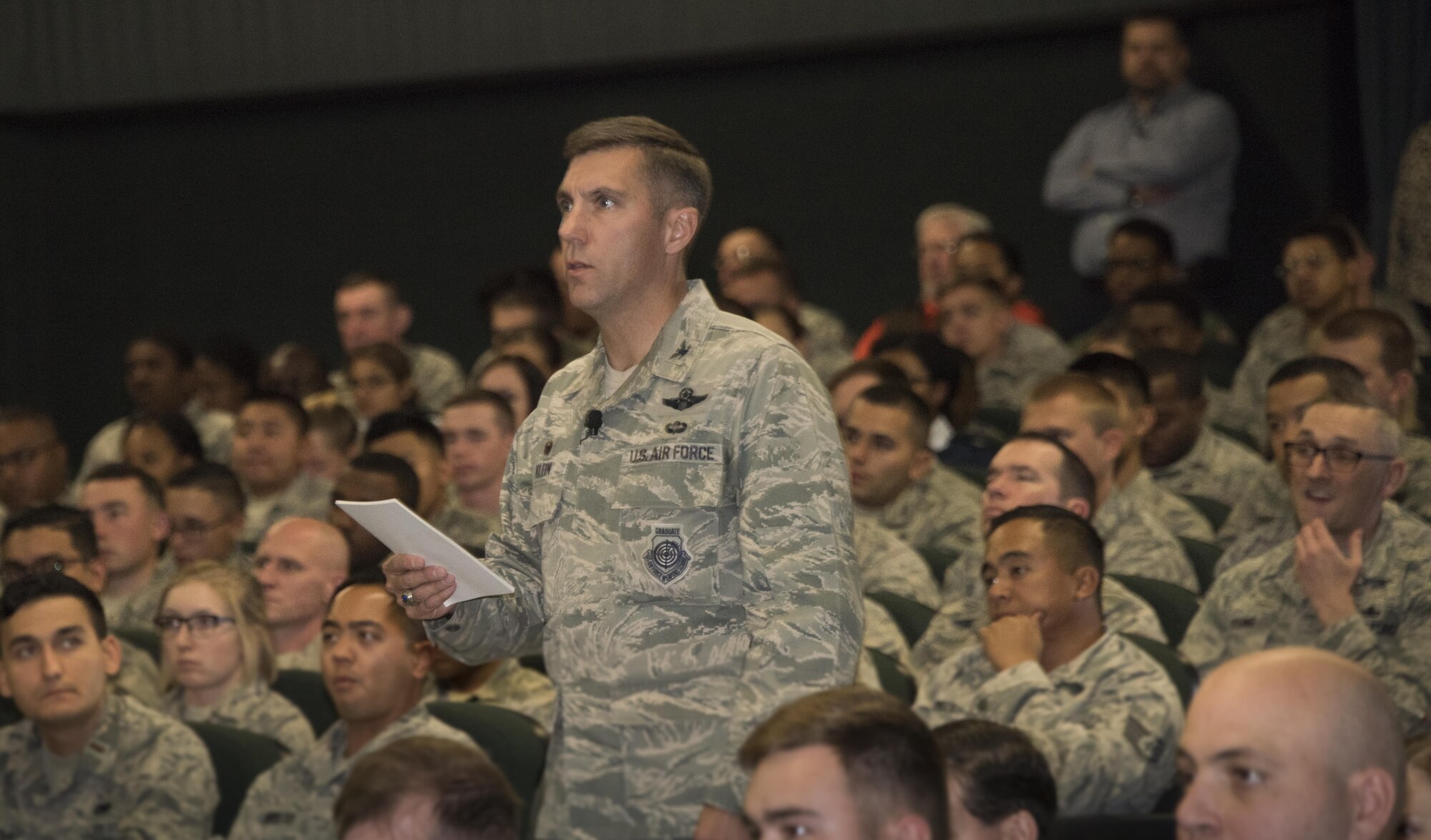 U.S. Air Force Col. John Klein, the commanding officer of the 60th Air Mobility Wing, addresses the audience during an All Call at the Base Theater, Nov. 6, 2017, Travis Air force Base Calif. Klein spoke about leadership, pride and maintaining readiness. (U.S. Air Force photo by Heide Couch)