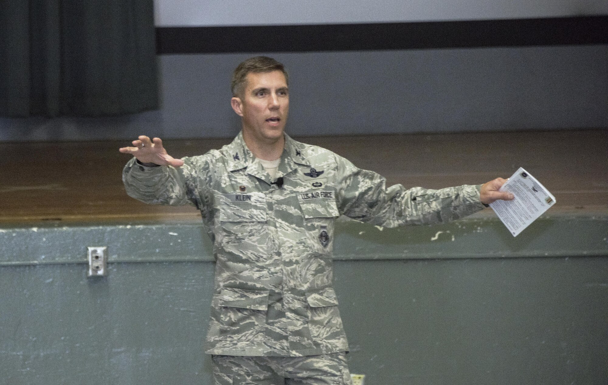 U.S. Air Force Col. John Klein, the commanding officer of the 60th Air Mobility Wing, addresses the audience during an All Call at the Base Theater, Nov. 6, 2017, Travis Air force Base Calif. Klein spoke about leadership, pride and maintaining readiness. (U.S. Air Force photo by Heide Couch)