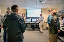 Honorary commanders visit the 60th Communication Squadron during a tour of the 60th Mission Support Group, Nov. 3, 2017, at Travis Air Force Base, Calif.  The purpose of the Travis Air Force Base Honorary Commander Program is to promote relationships between base senior leadership and civilian partners, foster civic appreciation of the Air Force mission and its Airmen, maximize opportunities to share the Air Force story with new stewards, and to communicate mutual interest, challenges, and concerns that senior leaders and civilian stakeholders have in common. (U.S. Air Force photo by Louis Briscese)