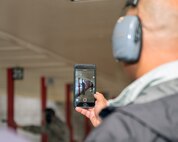 An honorary commander takes a video of a defender from the 60th Security Force Squadron Humvee during their tour of the 60th Mission Support Group, Nov. 3, 2017 at Travis Air Force Bace, Calif. The purpose of the Travis Air Force Base Honorary Commander Program is to promote relationships between base senior leadership and civilian partners, foster civic appreciation of the Air Force mission and its Airmen, maximize opportunities to share the Air Force story with new stewards, and to communicate mutual interest, challenges, and concerns that senior leaders and civilian stakeholders have in common. (U.S. Air Force photo by Louis Briscese)