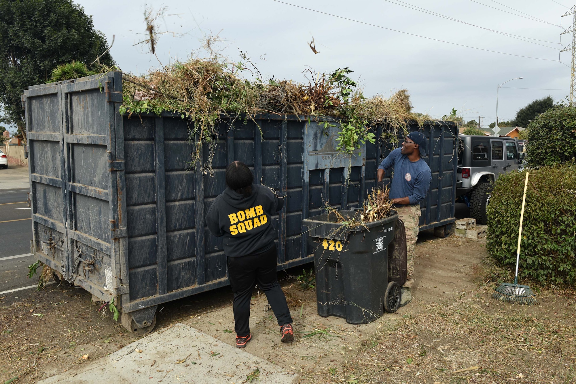 Vandenberg Airmen work together to support a Korean War veteran, Nov. 4, 2017, Santa Maria, Calif. The Airmen cleared out more than 6,000 pounds of green waste to save the Santa Maria home. (U.S. Air Force photo by Tech. Sgt. Jim Araos/Released)