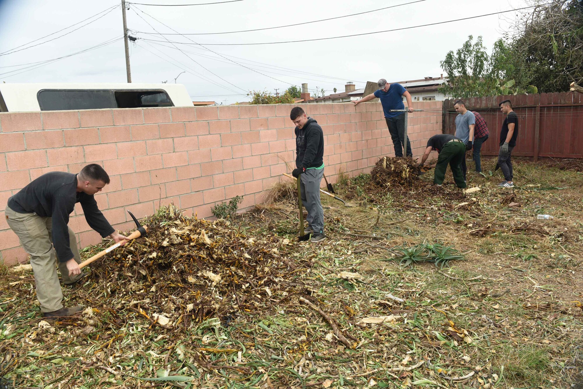 Vandenberg Airmen work together to support a Korean War veteran, Nov. 4, 2017, Santa Maria, Calif. The Airmen cleared out more than 6,000 pounds of green waste to save the Santa Maria home. (U.S. Air Force photo by Tech. Sgt. Jim Araos/Released)