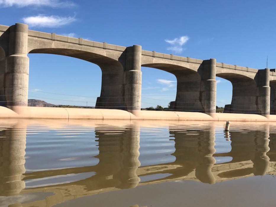 CONCHAS DAM, N.M. – The dam reflects in the lake, Oct. 17, 2017. The day was very calm with an elevation of 4195.22 and recent rains caused the water to be a muddy brown color. Photo by Nadine Carter. This 2017 Photo Drive entry placed third based on employee voting.