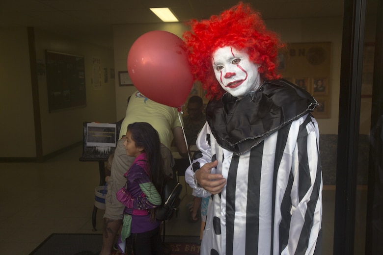 Sgt. Maj. Phillip Billiot, sergeant major of Headquarters Battalion (HQBN), dresses up as Stephen King’s “Pennywise” character during the Trunk-or-Treat Halloween event, Marine Corps Base Hawaii (MCBH), Oct. 27, 2017. The event invited Marines, Sailors, and their families to dress up, decorate their vehicles, and attend the haunted house organized by the battalion’s family readiness officer and senior leadership. Social events hosted aboard MCBH accommodate a positive community which fosters, develops and promotes resiliency within the installation. (U.S. Marine Corps photo by Lance Cpl. Luke Kuennen)