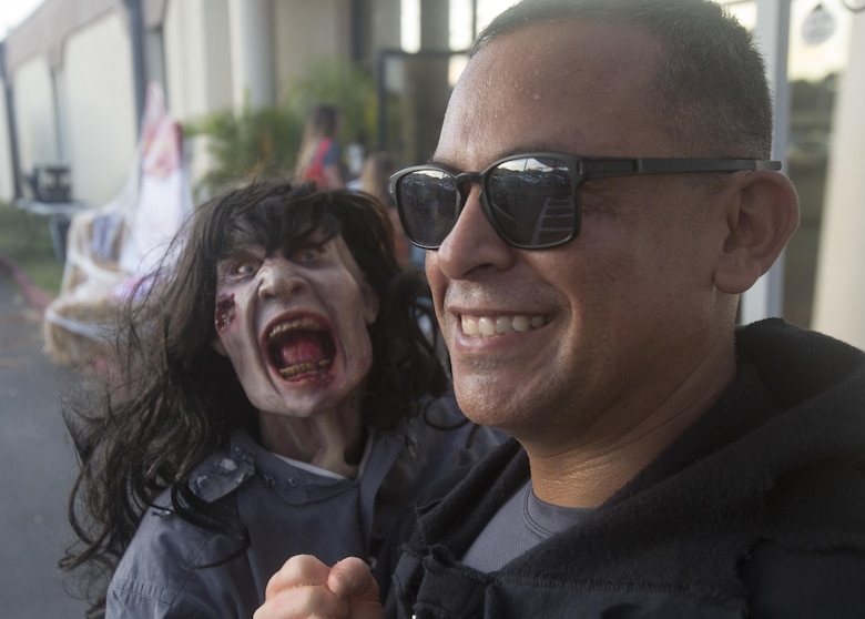A U.S. Marine with Headquarters Battalion (HQBN), Marine Corps Base Hawaii (MCBH), poses for a photo during the Trunk-or-Treat Halloween event, MCBH, Oct. 27, 2017. The event invited Marines, Sailors, and their families to dress up, decorate their vehicles, and attend the haunted house organized by the battalion’s family readiness officer and senior leadership. Social events hosted aboard MCBH accommodate a positive community which fosters, develops and promotes resiliency within the installation. (U.S. Marine Corps photo by Lance Cpl. Luke Kuennen)