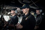 SEA OF JAPAN (Oct. 17, 2017) Gas Turbine Systems Technician (Electrical) 3rd Class Cori Odenbreit, left, from Burlington, Wash., Quartermaster 3rd Class Zoy Malamatos, from Staten Island, N.Y., and Ensign Jordan O’Briant, from Calhoun, La., man the helm on the bridge of the Arleigh Burke-class guided-missile destroyer USS Chafee (DDG 90), during a replenishment-at-sea with USNS Wally Schirra (T-AKE 8).