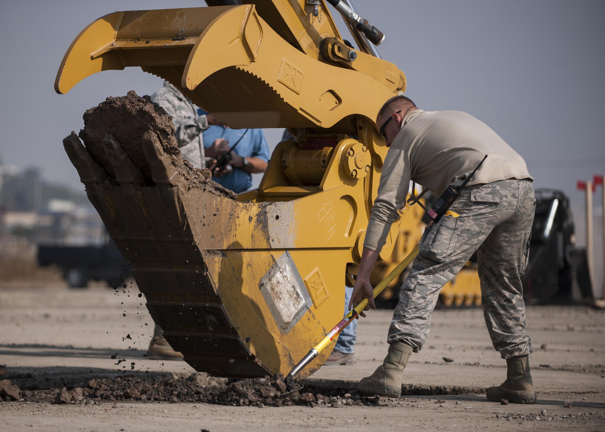 U.S. Air Force Senior Airman Kyle Gibson, 8th Civil Engineer Squadron Water and Fuel Systems Maintenance journeyman, helps to clear debris during rapid airfield damage repair training at Kunsan Air Base, Republic of Korea, Oct. 25, 2017. The new RADR process was developed by the Air Force Civil Engineer Center to repair damaged airfields at a faster pace. (U.S. Air Force photo by Staff Sgt. Victoria H. Taylor)