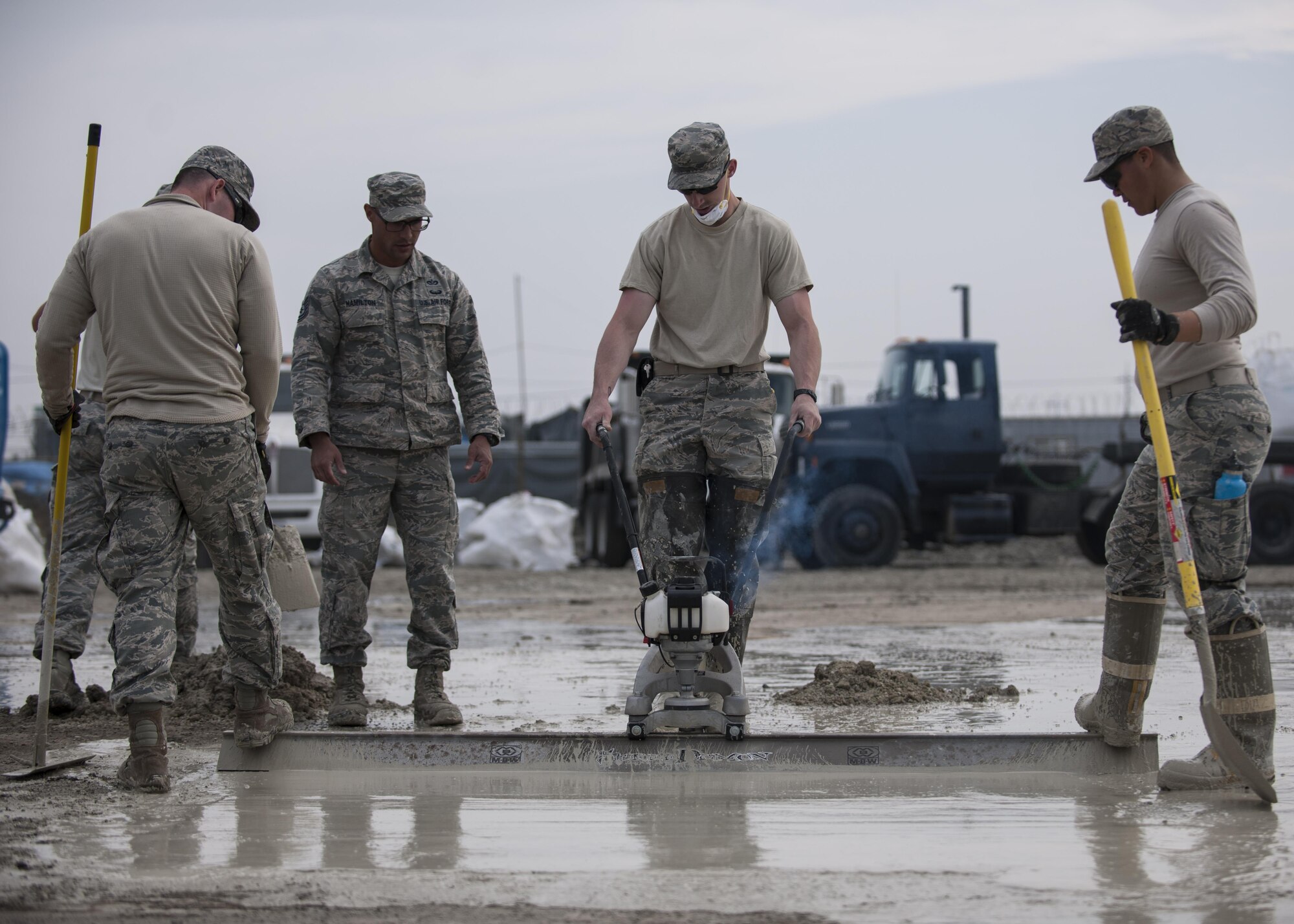 U.S. Air Force Airmen assigned to the 8th Civil Engineer Squadron finish patching a damaged area during rapid airfield damage repair training at Kunsan Air Base, Republic of Korea, Oct. 26, 2017. Members from the Air Force Civil Engineer Center, Tyndall Air Force Base, Fla., instructed Airmen assigned to the 8th CES on the new RADR process. (U.S. Air Force photo by Staff Sgt. Victoria H. Taylor)