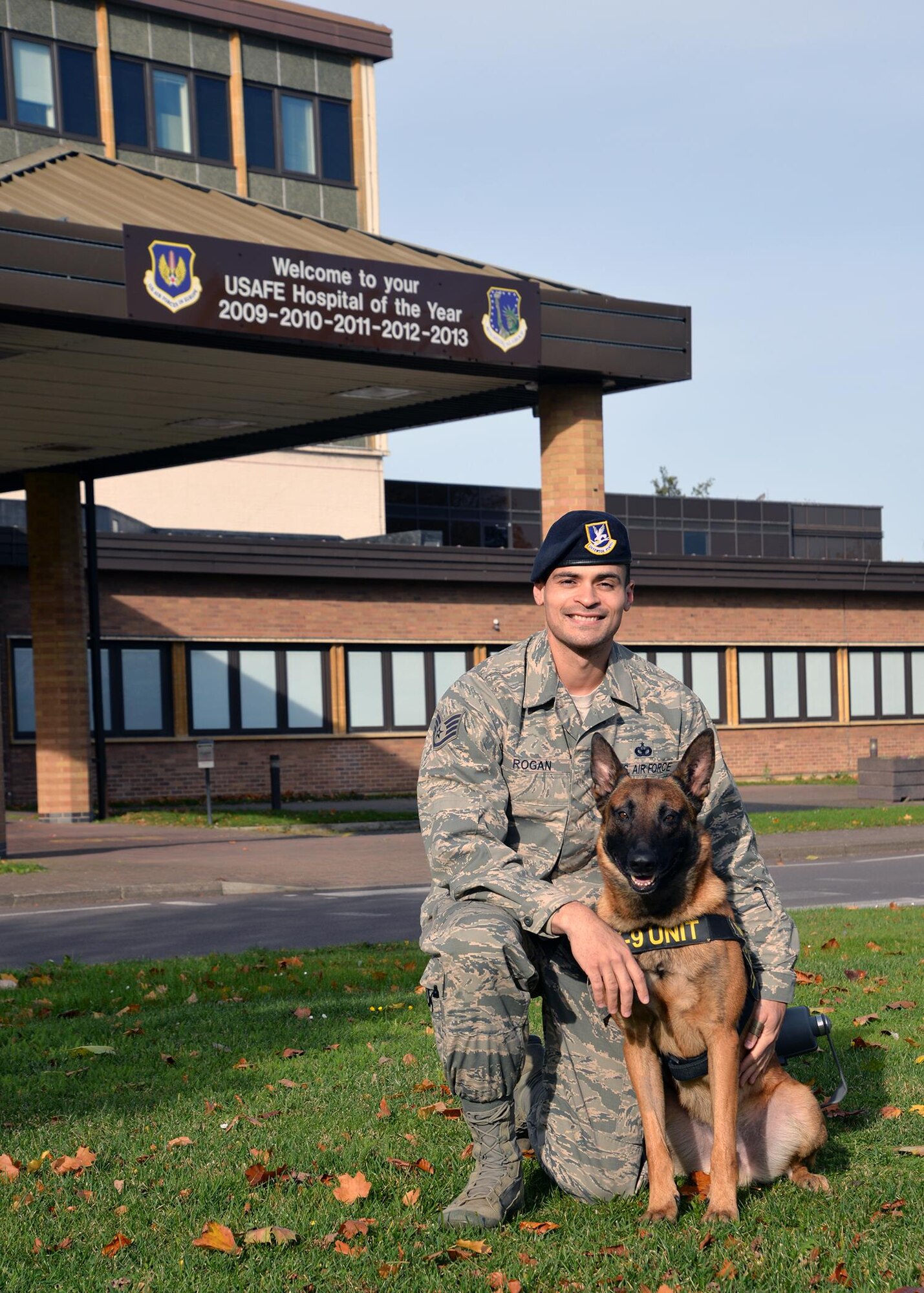 U.S. Air Force Staff Sgt. Alexandre Rogan, 100th Security Forces Squadron Military Working Dog handler and trainer, and his partner, MWD Oorion, pose for a photo Oct. 30, 2017, outside the 48th Medical Group on RAF Lakenheath, England.  Rogan was recently accepted to become an officer in the Medical Service Corps – an extremely competitive career field of just 950 people – and underwent job-shadowing for six months at the medical group as an additional part of his submission package. (U.S. Air Force photo by Karen Abeyasekere)