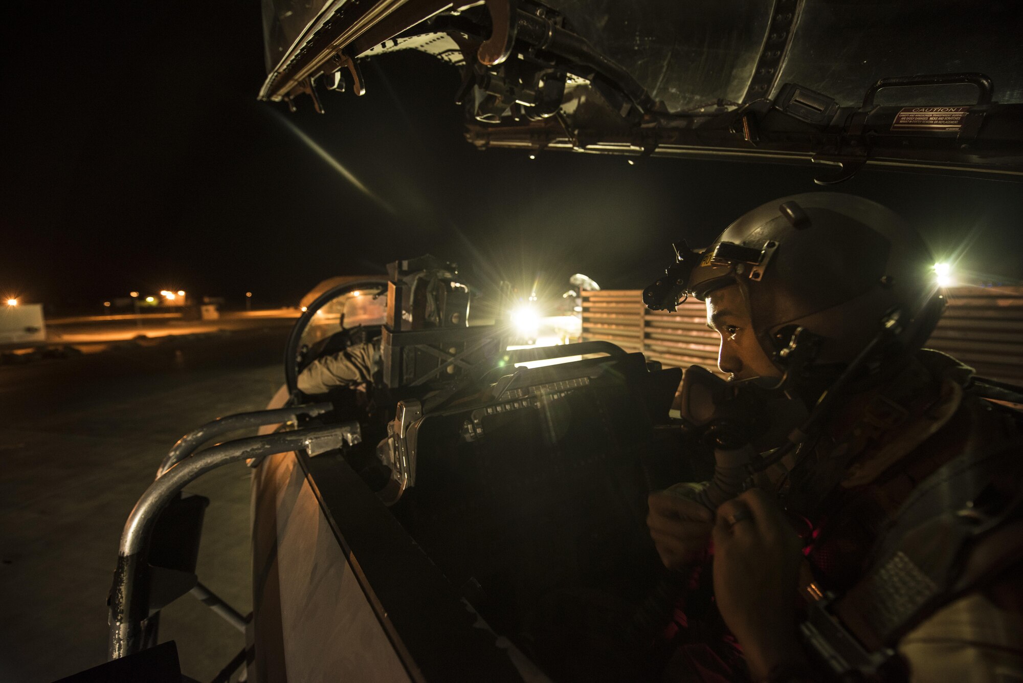 An aircrew member assigned to the 336th Expeditionary Fighter Squadron prepares his equipment for a sortie in support of Operation Inherent Resolve objectives November 3, 2017 in Southwest Asia. The 336th EFS flies the F-15E Strike Eagle, a dual-role fighter designed to excel in both air-to-air and air-to-ground missions. (U.S. Air Force photo by Senior Airman Joshua Kleinholz)