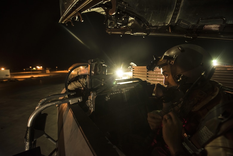 An aircrew member assigned to the 336th Expeditionary Fighter Squadron prepares his equipment for a sortie in support of Operation Inherent Resolve objectives November 3, 2017 in Southwest Asia. The 336th EFS flies the F-15E Strike Eagle, a dual-role fighter designed to excel in both air-to-air and air-to-ground missions. (U.S. Air Force photo by Senior Airman Joshua Kleinholz)