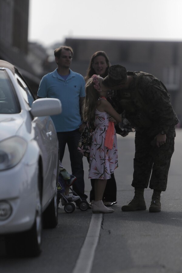 Sgt. James Nero kisses his daughter prior to the Warsaw Veterans Day Parade in Warsaw, N.C., Nov. 4, 2017. Hundreds of attendees gathered for the 97th Annual Veterans Day Parade in Warsaw to recognize and celebrate America’s veterans and active duty service members. Nero is a field artillery cannoneer with 1st Battalion, 10th Marine Regiment, 2d Marine Division. (U.S. Marine Corps photo by Sgt. Sean J. Berry)