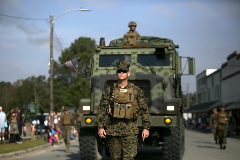 Sgt. James Nero ground guides a 7-ton during the Warsaw Veterans Day Parade