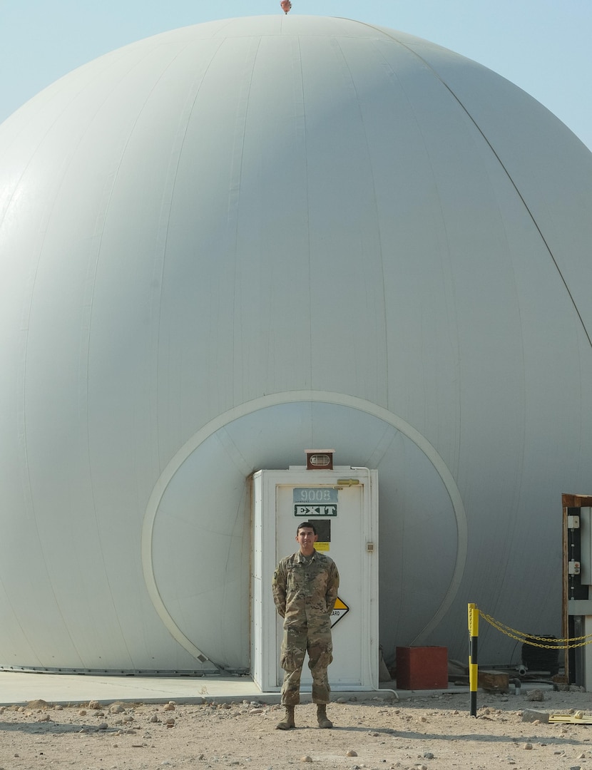 CAMP BUEHRING, Kuwait – Sgt. Richard Bosquez, F Company, 2-149th General Support Aviation Battalion’s acting facility chief at Udairi Landing Zone, poses for a picture in front of the Radome, which houses the Air Traffic Navigation, Integration, Coordination System at Camp Buehring, Kuwait, Oct. 19, 2017. F Co. Soldiers provide air traffic services and airfield management at multiple locations in both Kuwait and Iraq. (U.S. Army photo by Capt. Stephen James)