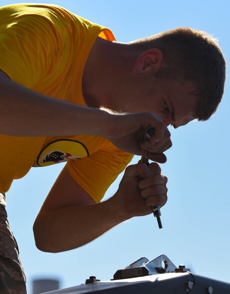 U.S. Air Force Airman 1st Class Zachery Semmer, 27th Aircraft Maintenance Unit load crew member, prepares to load a preloaded weapons rack to be loaded on to a U.S. Air Force F-22 Raptor during the 3rd Quarter Weapons Load Competition at Joint Base Langley-Eustis, Va., Nov. 3, 2017.