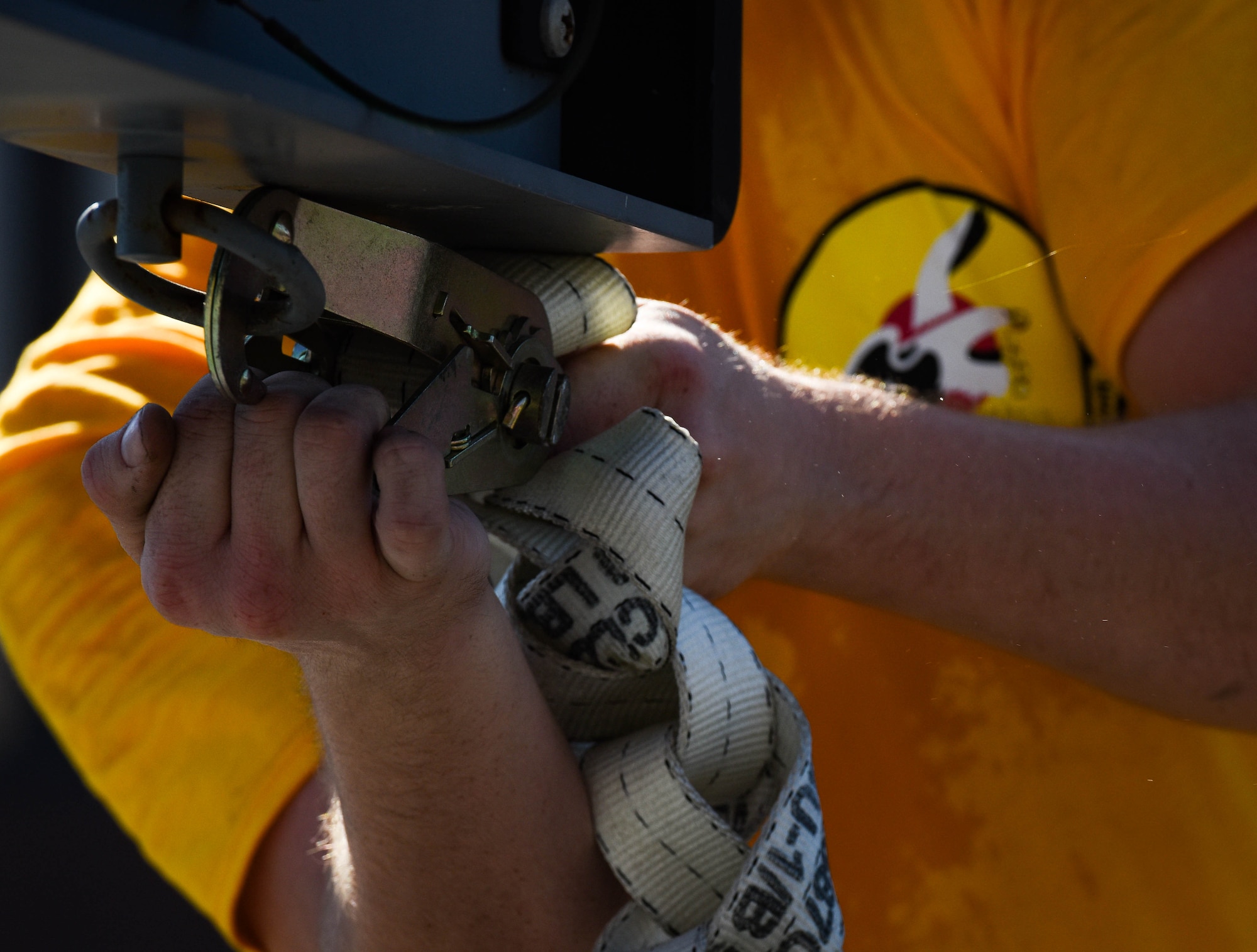 U.S. Air Force Airman 1st Class Cody Rhodes, 27th Aircraft Maintenance Unit load crew member, tightens straps on a missile rack during the 3rd Quarter Weapons Load Competition at Joint Base Langley-Eustis, Va., Nov. 3, 2017.